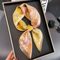 Silk square scarf with yellow and orange marble print displayed on a black tray - 65cmx65cm / Orange Yellow (ZC-198)