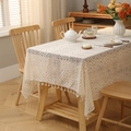 Bohemian ivory hollowed-out lace tablecloth with elegant tassels on a wooden dining table - Beige Torch Flower