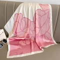 Close-up of camellia silk scarf draped on a leather sofa with gradient pink floral patterns - 70*70cm / Pink
