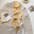 Detail of double-sided twilly scarf featuring floral pattern and script on a blazer - Yellow Floral Grid (CT-394)