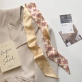 Close-up of narrow silk scarf featuring checkerboard heart patterns and script text - Heart Checkerboard (CT-393)