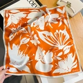 Detail of silk square scarf showing floral butterfly print and rolled edge finishing - 53*53cm / Orange