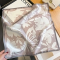 Detail of premium silk scarf with lily print and elegant hand-rolled edges on wooden table - 53*53cm / Pink Purple