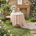 Creamy lace tablecloth with floral embroidery and ruffled edges in a garden setting - French Peony Ruffle - Beige