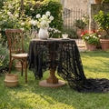 Elegant black floral lace tablecloth with intricate cutout patterns and ruffled edges - French Peony Ruffle - Black