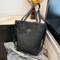 Fashionable black leather tote bag with embossed skull patterns and silver skull buckle - Black