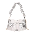 Metallic silver pleated shoulder bag featuring a translucent white bow and gold chain strap - Silver