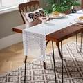 Macro shot of white lace table runner with geometric mesh patterns and pompom tassels - Greek Key Square White Pompom / 35*220cm