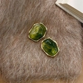 Macro shot of gold irregular geometric earrings with olive green resin stones - Ocean Green Polygon (E0287)