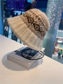 Close-up of Fair Isle knit beanie featuring fluffy mohair texture and jacquard pattern - Beige Khaki