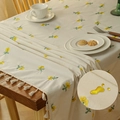 Beige floral embroidered tablecloth with yellow flowers, fringe edges, and waterproof finish - Sunflower