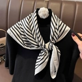 Elegant black and white striped silk scarf with camellia flower on a black sweater - Beige-Black