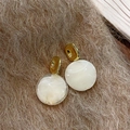 Retro amber resin round stud earrings with gold metal squares on brown fuzzy fabric - Ivory