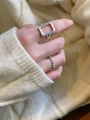Close-up of geometric rectangular ring and beaded stackable bands on a model's hand - Hollow Square Style (K112)