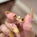 Detailed view of red and zircon clover charms on a gold-plated adjustable ring - K53 Clover Flower Adjustable Ring