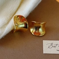 Detail of 18K gold plated crescent earrings featuring brushed texture on brown backdrop - Gold (18K Gold Plated Wide Curved Style)