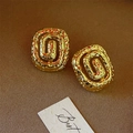 Close-up of golden lava texture spiral flower stud earrings with hammered finish - Gold-tone Spiral Flower