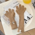 Close-up of camel knit gloves with ribbed texture on a decorative tray background - One Size / Khaki