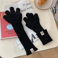 Detail of black knitted gloves with designer woven label and ribbed texture detail - One Size / Black