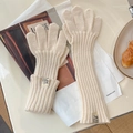 Detailed texture of cream knit gloves with vertical ribbed weave and extended cuffs - One Size / Beige