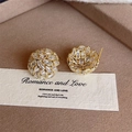 Macro detail of gold floral stud earrings with marquise-cut crystals on brown velvet - Gold Hydrangea Style (E2267)
