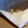 Gold C-shaped stud earrings with rectangular cubic zirconia on a knit background - Gold - Zirconia Square