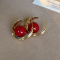 Close-up of vintage gold twist C-shape earrings with a glossy red pearl inlay - Twist Edge Red Pearl (E1280) / 15mm