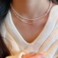 Double-layered pearl and silver bead necklace on model with white V-neck sweater - Silver Beads & Glass Pearl Layered Necklace (X364+X201) / Silver-White Layered Double Necklace