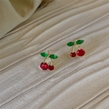 Close-up of cherry-shaped stud earrings with red and green crystals on a beige background - Green Leaf Cherry (E2942)