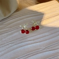 Cute cherry earrings with red stones and gold leaves on a textured cream display - Micro-paved Leaf Cherry (E2941)