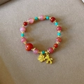 Macro view of strawberry quartz beads with golden horse and flower charms - Strawberry Quartz Qiji Horse (C342)
