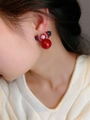 Detail of red beaded bow earrings with glossy spherical pendant worn by a model - Vintage French Red Pearl Crystal Bow