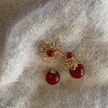 Elegant fireworks starburst earrings with red pearls on a soft white faux fur background - Front and Back Wear Fireworks Pearl