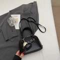 Elegant black shell-shaped handbag with heart charm and adjustable shoulder strap - Black (With Charm)