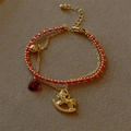 Detail of red woven cord bracelet with gold beads, rocking horse, and heart charms - Red Heart Rocking Horse Double Layer (C007)