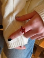 Handmade red beaded flower ring with gold center accent on white knit backdrop - Matching Plum Blossom Ring