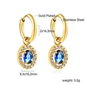 Close-up of gold stainless steel oval hoop earrings with blue stone and white crystals - Gold Blue Stone Style (EA59910KG)