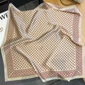 Macro detail of silk square scarf with vintage pattern on a wooden surface background - 70x70cm / Beige