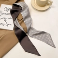 Close-up of double-sided silk skinny scarf with star pattern on a warm desktop - Origami Crane