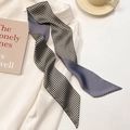 Detail of grey and checkered skinny silk scarf styled on a white professional shirt - Houndstooth