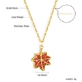 Detailed view of 18K gold plated maple leaf pendant with dimensions and chain specs - Red Zircon Style (NE2B750EG)