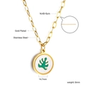 Detail of 18K gold plated paperclip chain and green monstera leaf pendant on white shell - Gold Monstera Leaf Style (NE2A720MG)