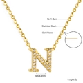 Detailed close-up of crystal paved letter N pendant on gold-plated stainless steel chain - Gold Letter N