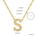 Macro detail of gold plated S letter pendant necklace with sparkling white zircons - Gold Letter S