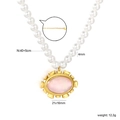 Elegant gold-tone oval pink shell pendant on a 4mm white pearl necklace with adjustable chain - French Vintage Pink Shell Pendant (NE2H110FG)