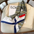 Detail of silk scarf with paisley pattern draped over a beige blazer for styling - 70x70cm / Army Green Blue Edge