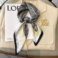 French style paisley silk scarf in black and gold tied as a bow on a white blazer - 70x70cm / Natural With Black Edge