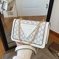 White square shoulder bag with repeating M patterns and golden chain strap detail - White