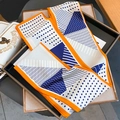 Close-up of a geometric patterned silk scarf with orange borders on a metal tray - 145cm / Orange Border (ZJ-171-Orange Border)