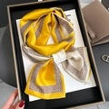 Detalle de pañuelo de seda en tonos amarillos y crema con diseño geométrico - Amarillo